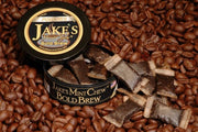 Open can of Jake's Mint Chew Bold Brew pouches displayed on a bed of coffee beans, showcasing a tobacco-free and nicotine-free alternative