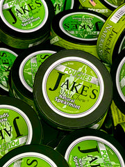 Multiple tins of Jake's Mint Chew Natural Spearmint Pouches – an all-natural, tobacco-free, and nicotine-free alternative to chewing tobacco.